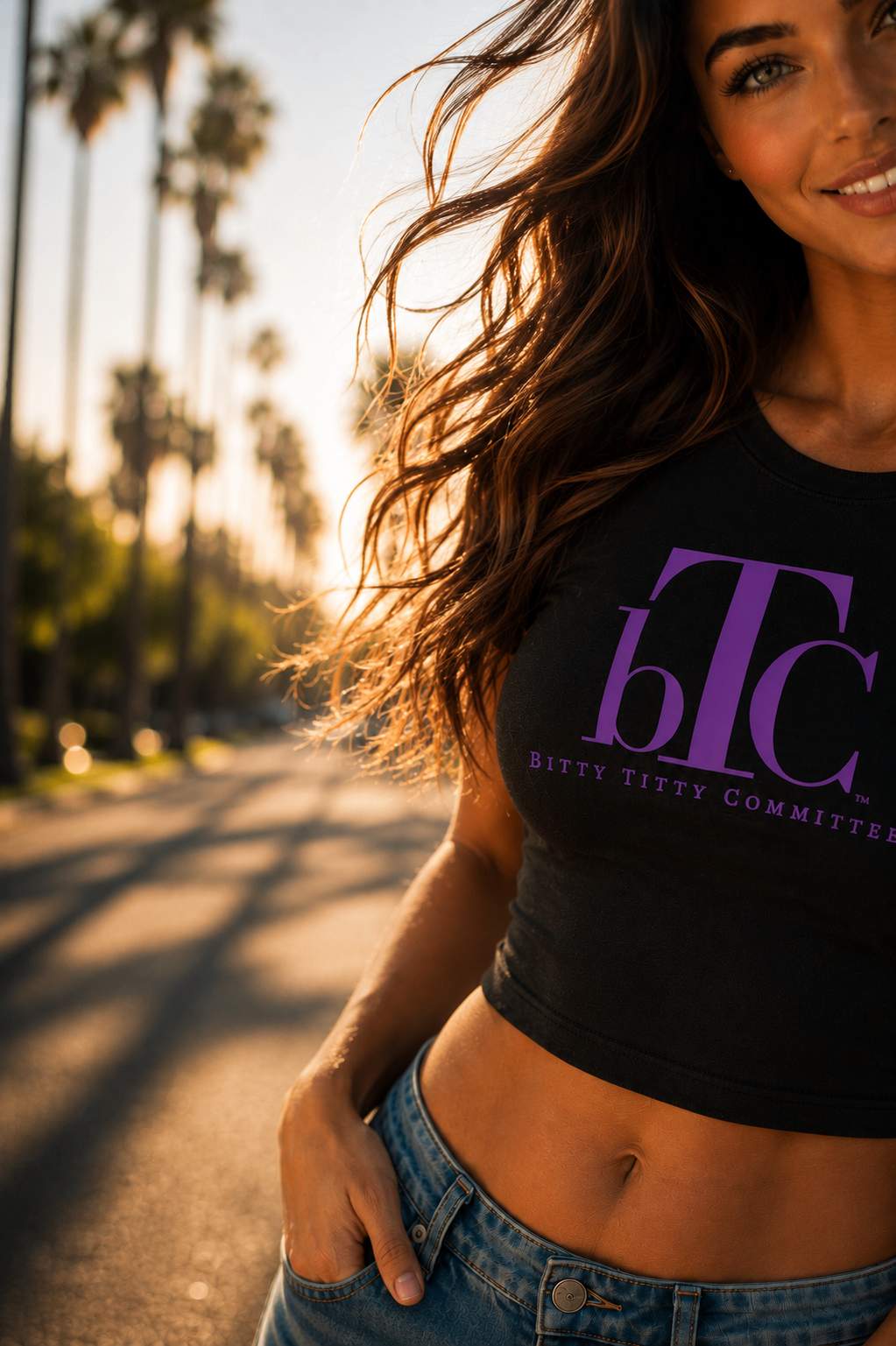 Woman in a bTC purple graphic tee, palm-lined street